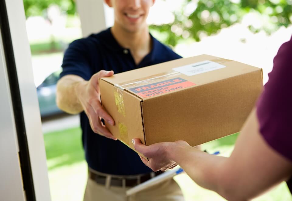 man delivering fragile package to a home